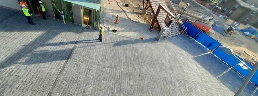 2 of 4, View from above of new sculpture that includes a walkway with rows of embossed words